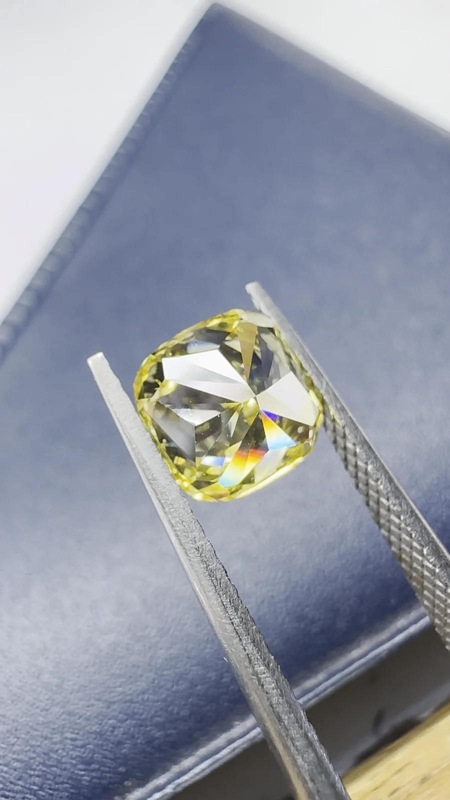A yellow cushion cut diamond on our grading desk
